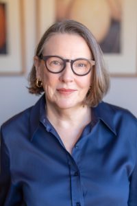 A portrait of Lucinda Holdforth looking into the camera with a small smile.