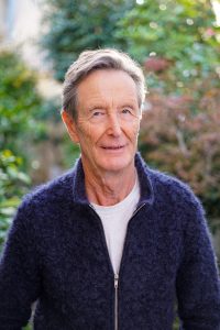 A portrait of Paul Barry in front of some trees.