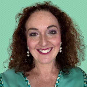Headshot of Sophie Green smiling against a solid, light green background.